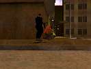 Player (black suit) bunching up too close to a bot (orange sweater) to fight the Sabotage security forces (while a downed body occupies the sidewalks)